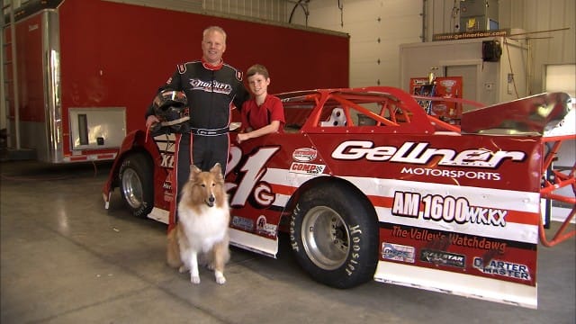 Photo of Gregory A. Gellner with son, racecar and dog
